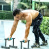 Heavy-duty parallel push-up bars in black with ergonomic grips and a non-slip base for strength training and calisthenics.