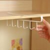 White multipurpose over-the-door organizer rack with multiple hooks for clothes, bags, and kitchen use.