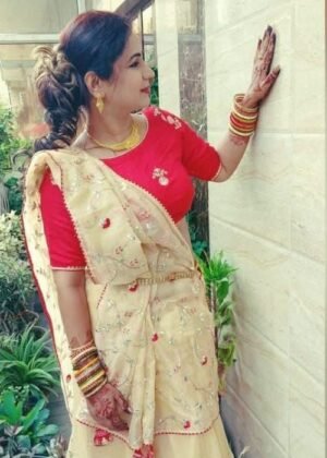 White soft organza saree with zari butti, heavy sequin embroidery, and intricate cutwork, styled with traditional jewelry.