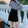 Women’s high-waist houndstooth print mini skirt, bodycon fit with elastic waistband for stylish comfort.