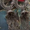 Handmade silver earrings with intricate circular design, bird motifs, and chain tassels.