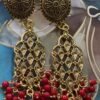 Handmade gold-plated earrings with intricate floral designs and red bead detailing.